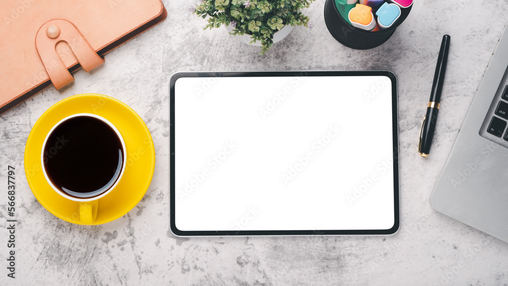 Office desk workplace with blank screen tablet, laptop, pen, notebook and cup of coffee, Top view flat lay. Office desk workplace with blank screen tablet, laptop, pen, notebook and cup of coffee, Top view flat lay.