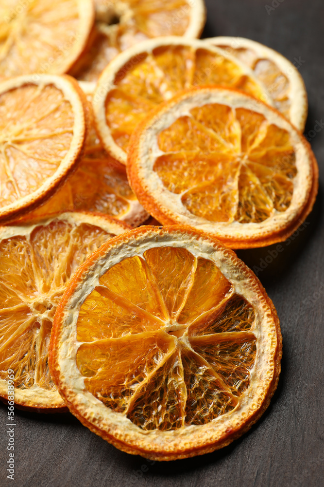 Dry orange slices on black table, closeup Dry orange slices on black table, closeup