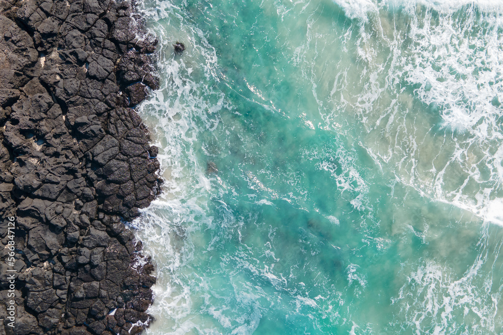 Sea and volcanic rocks close-up aerial view, natural background. - obrazy, fototapety, plakaty 