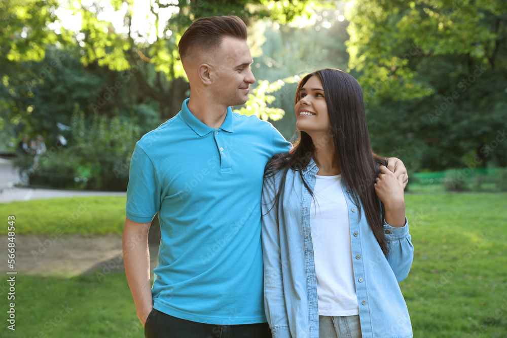 Affectionate happy young couple walking in park Affectionate happy young couple walking in park