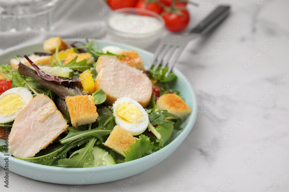 Delicious salad with croutons, chicken and eggs served on white marble table, closeup. Space for text Delicious salad with croutons, chicken and eggs served on white marble table, closeup. Space for text