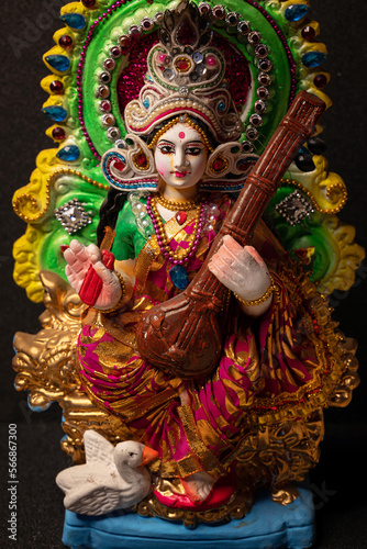 Idol of Goddess Devi Saraswati isolated on a black background. Close up photo