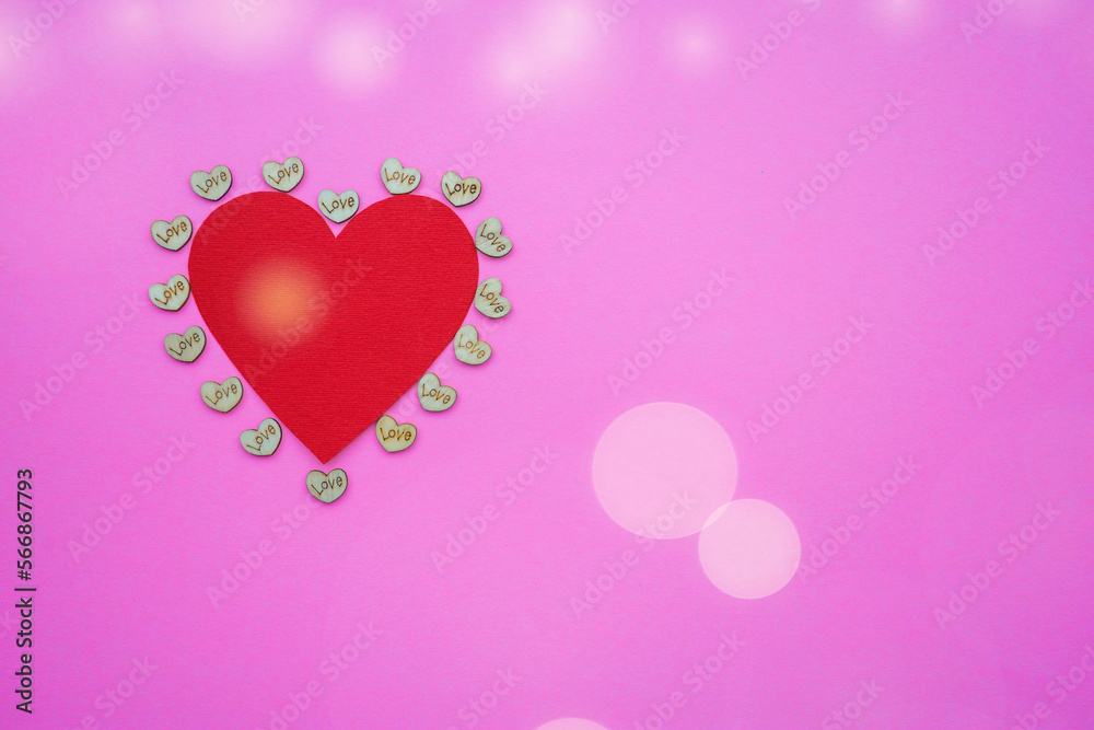 Red heart shape on abstract pink background in valentine's day love concept with sweet and romantic moment.