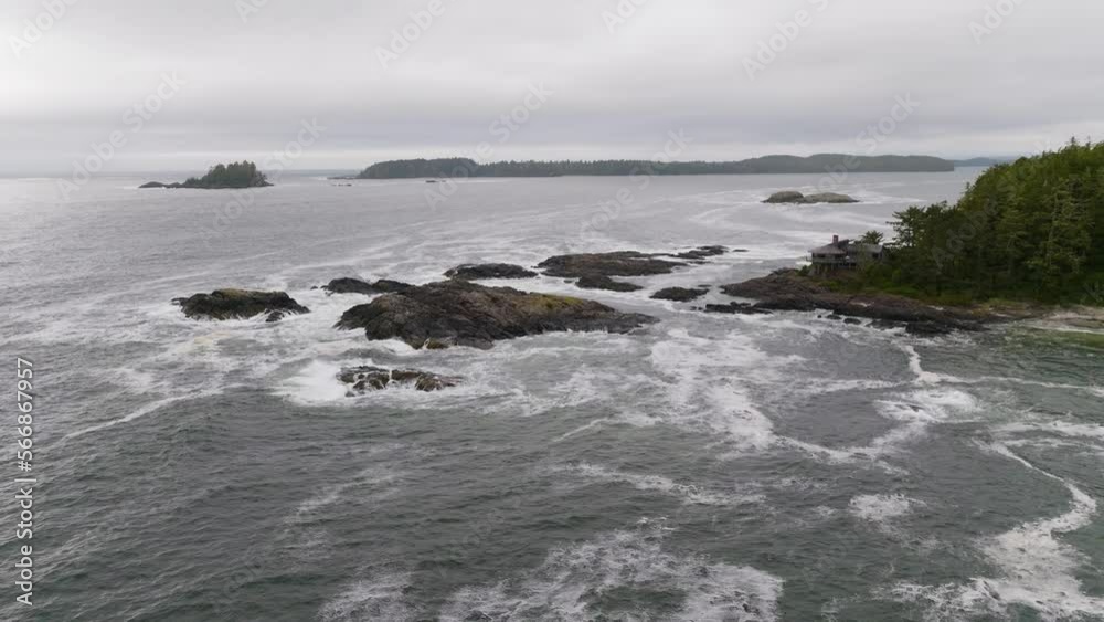 The rugged BC coastline, ocean waves crashing on rocks and the beach in Tofino British Columbia. Forest trees along the coast of Vancouver Island by the ocean of Clayoquot sound. The rugged BC coastline, ocean waves crashing on rocks and the beach in Tofino British Columbia. Forest trees along the coast of Vancouver Island by the ocean of Clayoquot sound.
