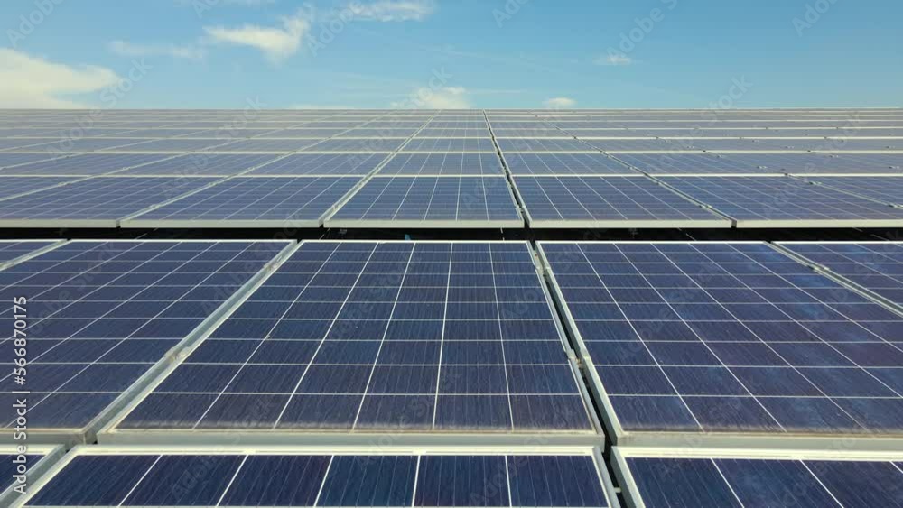 Aerial view of solar power plant with blue photovoltaic panels mounted on industrial building roof for producing green ecological electricity. Production of sustainable energy concept Aerial view of solar power plant with blue photovoltaic panels mounted on industrial building roof for producing green ecological electricity. Production of sustainable energy concept