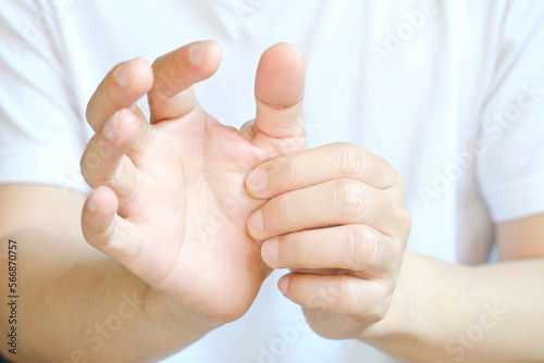 Konstfotografi Hand of man he massages his thumb and has finger pain, locked finger from work and office syndrome