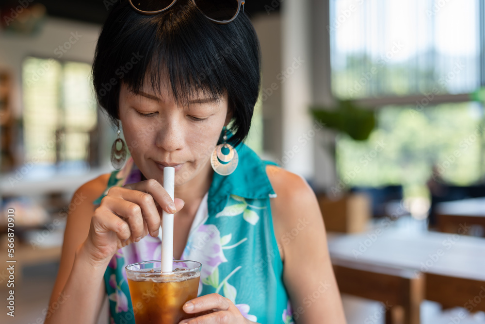 woman holding a cup of ice tea