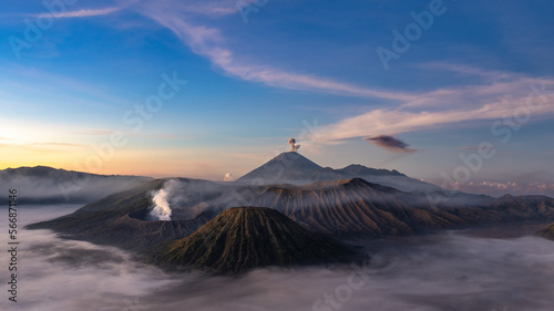 Mt Bromo at sunrise with fog and double eruption © Angiolo