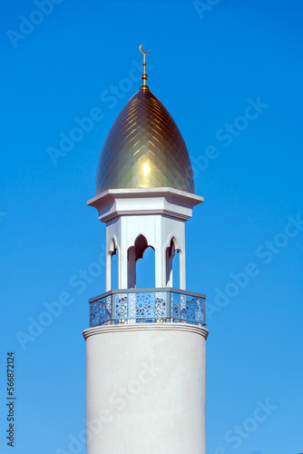 A Muslim golden dome with a crescent moon on the mosque. Minaret against the sky. Arab day. Islamic symbols of religion. Faith in Allah. Crescent moon at the top of the mosque photo