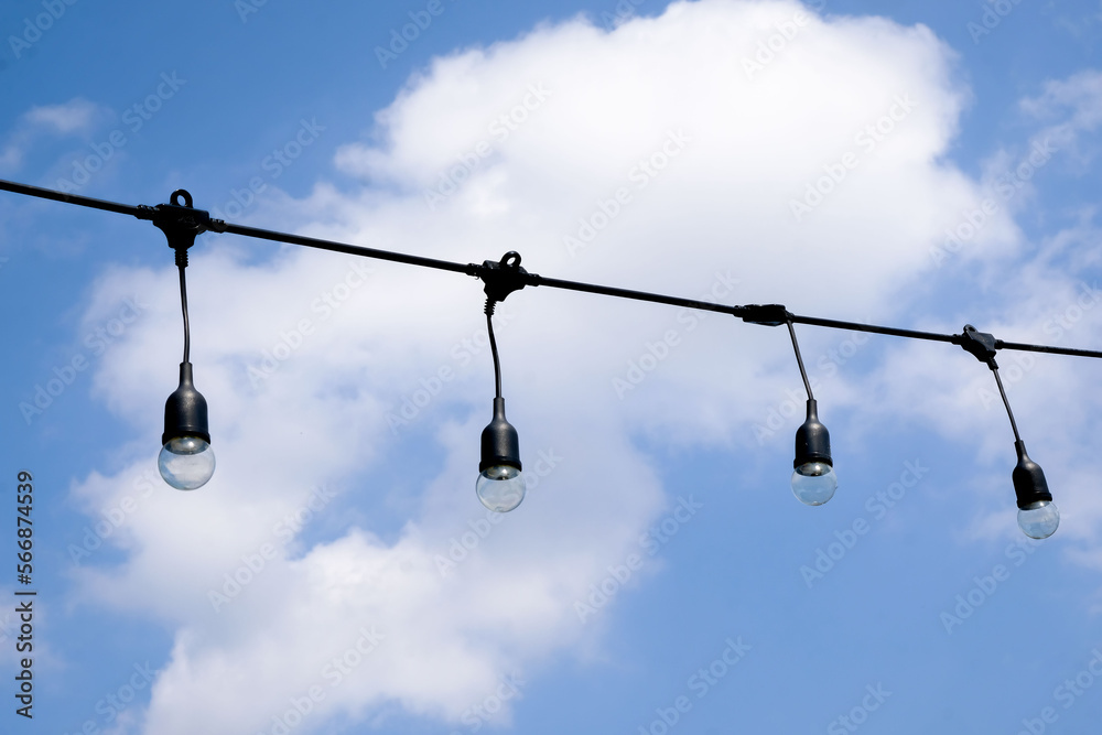 Clear string lights on blue sky background Clear string lights on blue sky background