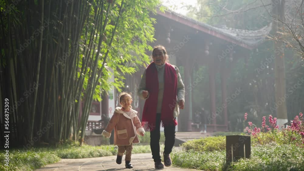 child playing in the sunny park with grandmother child playing in the sunny park with grandmother
