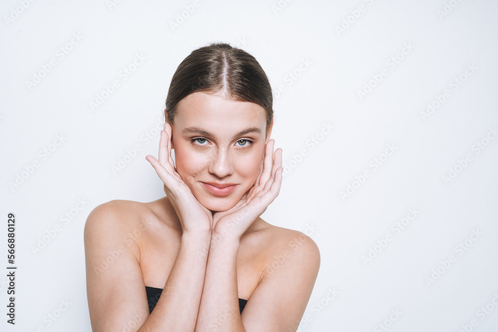 Beauty portrait of cute young girl with fresh skin tone looking at camera on white background isolated Beauty portrait of cute young girl with fresh skin tone looking at camera on white background isolated