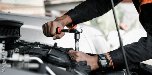 Mechanic fixing a car at home. Repair and service.