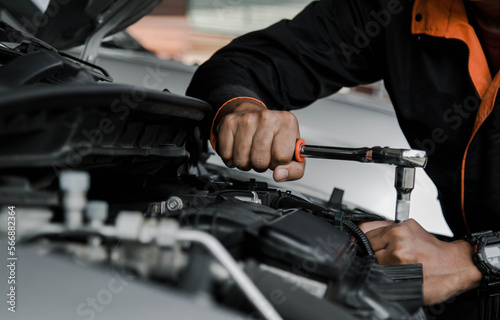 Mechanic fixing a car at home. Repair and service. © Nonthanat
