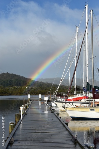 Pier with rainbow and yachts near the Wooden Boat Centre at Franklin, Cygnet, Tasmania. photo