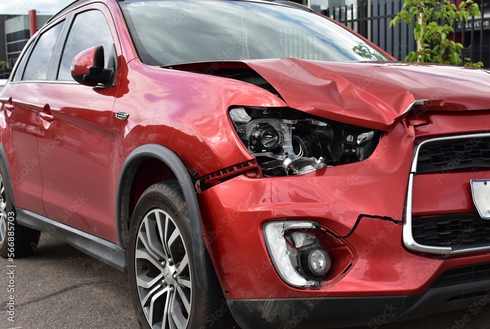A car showing auto panel and headlight damage for repair from a front end crash. A car showing auto panel and headlight damage for repair from a front end crash.