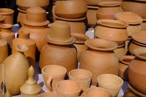 Terracotta, pot, cup kitchen souvenirs pile at street handicraft pottery shop. handmade terracotta Products in handicraft market in Pune, India.