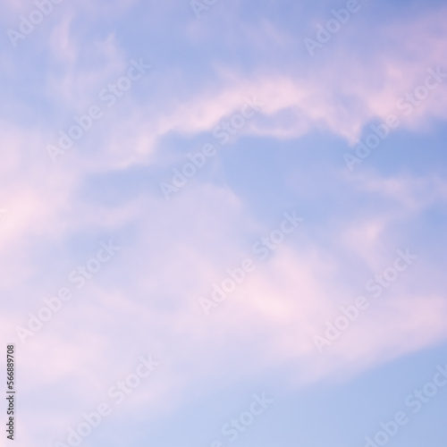 Blue sky background with white and pink clouds at sunset