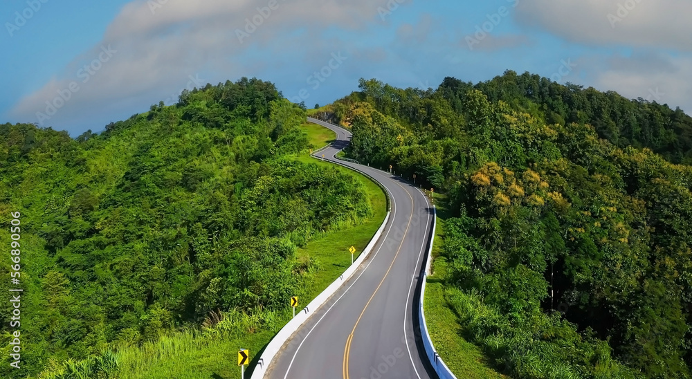 The highway stairs to the sky of road trough with green nature forest  as the natural landscape background
