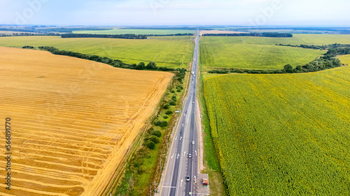 field road view from the top, sunflower field on a bright day © Антон Скрипачев
