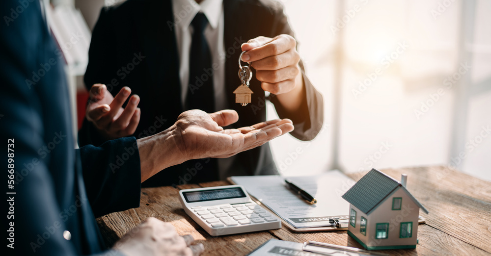 Fototapeta premium Signed the house buy a contract with the house sales agents. Buy or sell home concept. Happy in marketing signing contract of house .