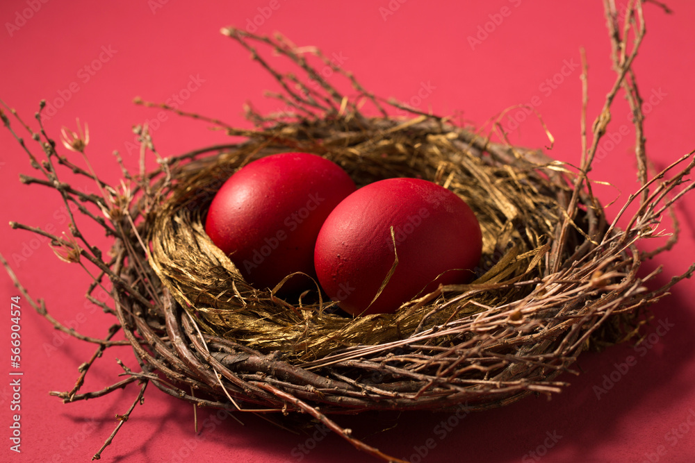Big red eggs in a nest on a pink background Big red eggs in a nest on a pink background