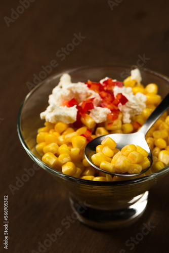 Esquites or Trolley with corn, cheese, mayonnaise and chili. Mexican street food. Close-up