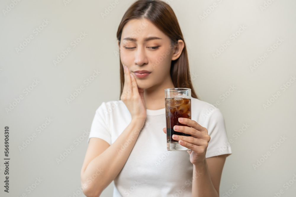 Health asian young woman touching her mouth, expression, suffering from toothache, decay or sensitivity cavity molar tooth or inflammation drink cold, sparkling water at home.Sensitive teeth people. Health asian young woman touching her mouth, expression, suffering from toothache, decay or sensitivity cavity molar tooth or inflammation drink cold, sparkling water at home.Sensitive teeth people.