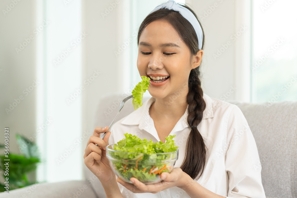 Diet, Dieting pretty attractive asian young woman, girl use fork at lettuce on mix vegetables, green salad bowl, eat food is low fat to good body. Nutritionist female, Weight loss for healthy person.