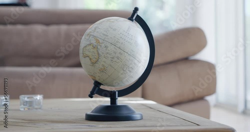 Rotation around a terrestrial globe placed on a living room table photo