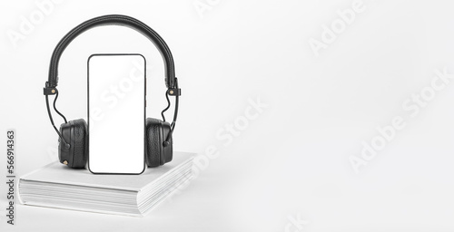 Mobile phone screen mock-up  book and headphones. Smartphone mockup for audio app  audiobook listening. Ads banner  promo background with copy space