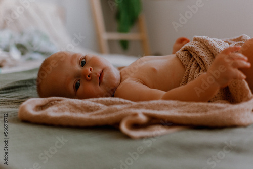 Cute newborn little baby boy in bed. Baby goods packaging template. Healthy child, concept of hospital and happy motherhood. Infant baby.
