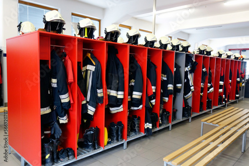 Interior of the fire station. Emergency wardrobe for firefighters to change clothes with hazmat suit, helmet and shoes. photo