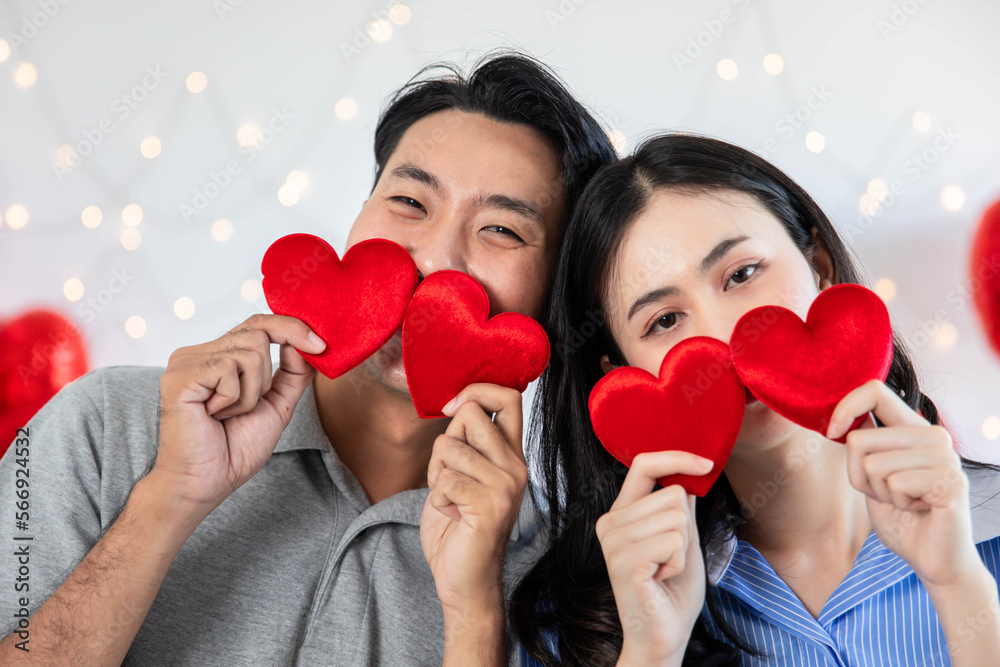 Couple in love holding red heart-shaped cards and smiling happy in Valentine's Day concept. Couple in love holding red heart-shaped cards and smiling happy in Valentine's Day concept.