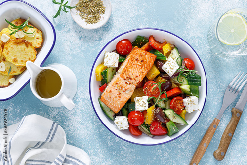 Greek salad with grilled salmon fish. Traditional mediterranean cuisine. Healthy food, diet. Top view
