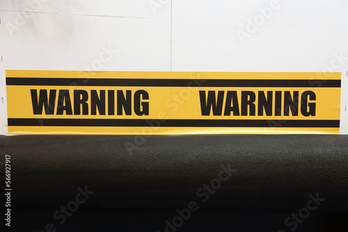 Warning word yellow and black color with line striped label banner