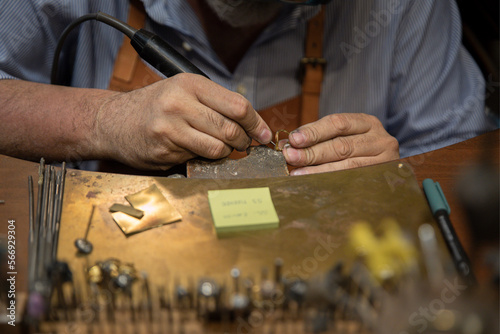 Silversmith working in an artisanal silversmith workshop in Florence, Italy