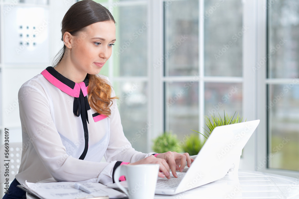 young woman working at table with laptop at home young woman working at table with laptop at home