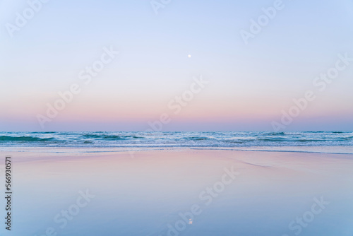 A calm sunrise in pastel colors on Hua Hin beach. Beautiful blank background.