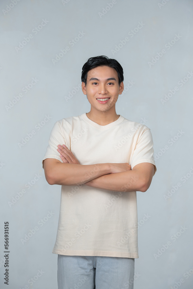 Portrait of a happy young man posing with arms crossed on a white background Portrait of a happy young man posing with arms crossed on a white background