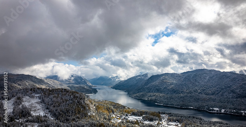 Cloudy sky over lake and hills © angelmaker