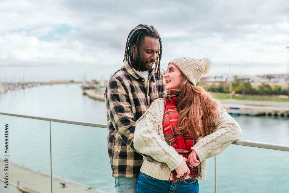 a multiethnic couple in love looking at each other and embracing a multiethnic couple in love looking at each other and embracing