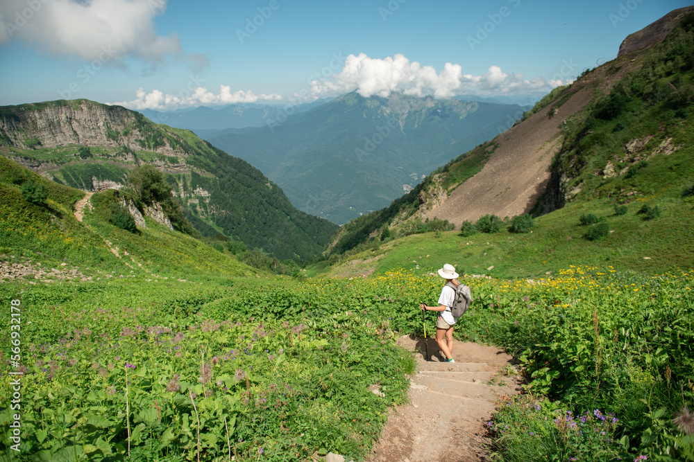 Female hiker with backpack and trekking poles hiking in mountains enjoying the scenic view during sunny day
Female hiker with backpack and trekking poles hiking in mountains enjoying the scenic view during sunny day