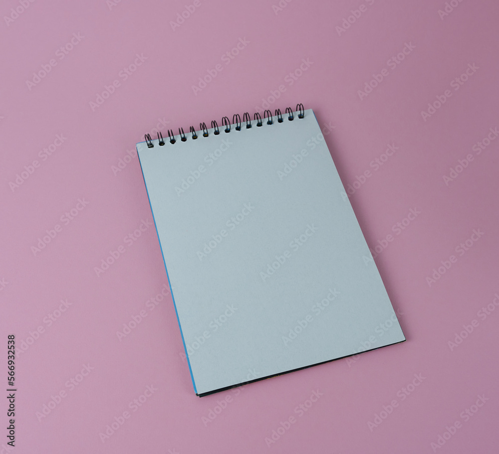 Notepad with spiral on a pink background, blank sheet. Notepad with spiral on a pink background, blank sheet.