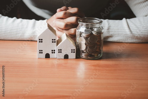 Hand with crate holding house and money jar.for buy house concept .for the future.