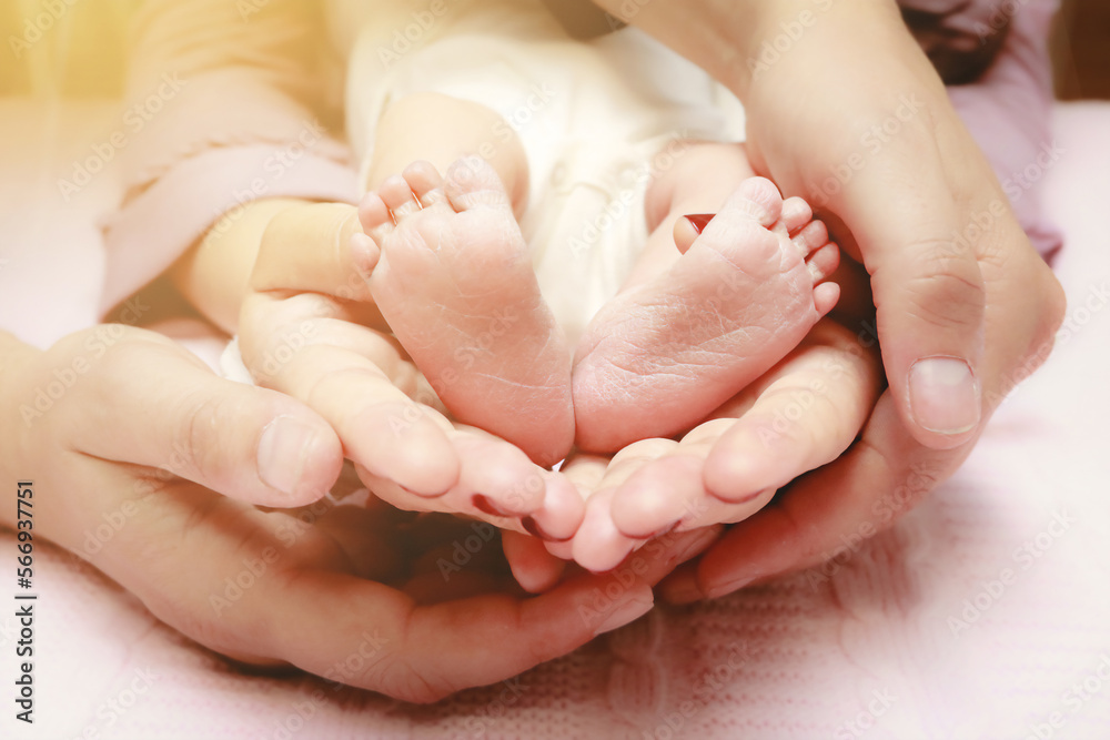 Baby feet in mother and father's hands. My parents and their child. Happy Family concept. Beautiful conceptual image of parenthood Baby feet in mother and father's hands. My parents and their child. Happy Family concept. Beautiful conceptual image of parenthood