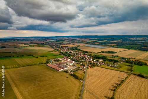 Aer ial view of a German village surrounded by meadows, farmland and forest in Germany. photo