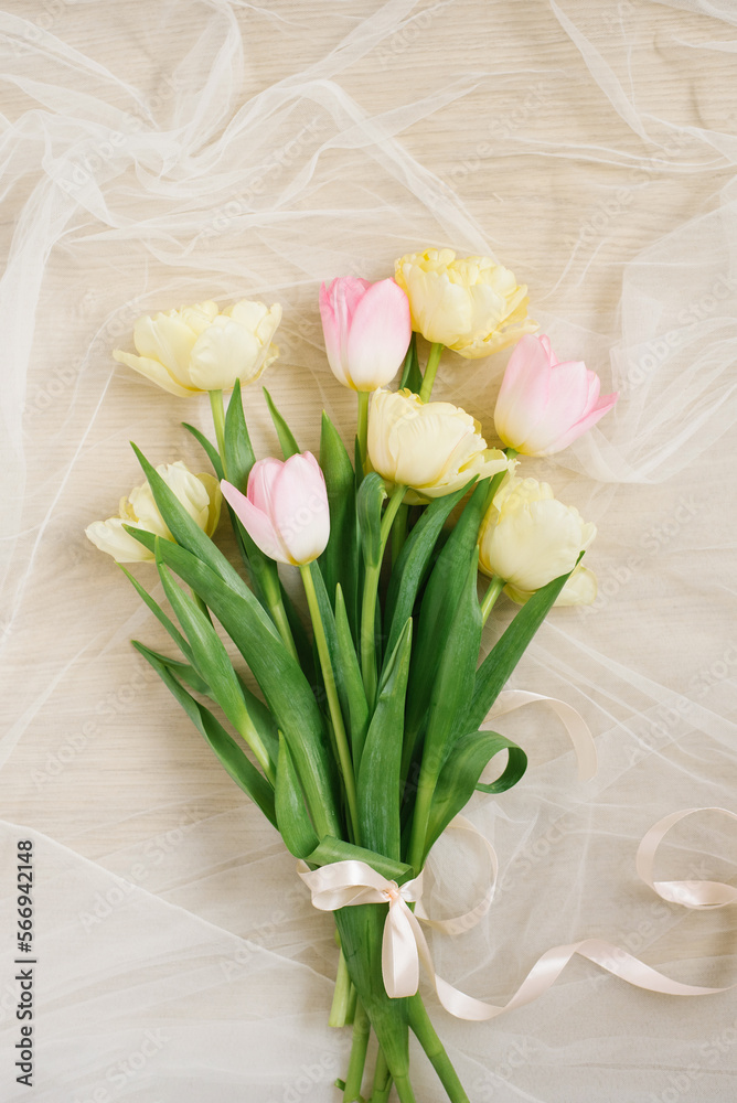 Obraz premium View from above tulip flowers pink and yellow color with copy space on beige background for womens day, 8 March Valentines day, 14 february. Flat lay style, top view, mockup, template, overhead
