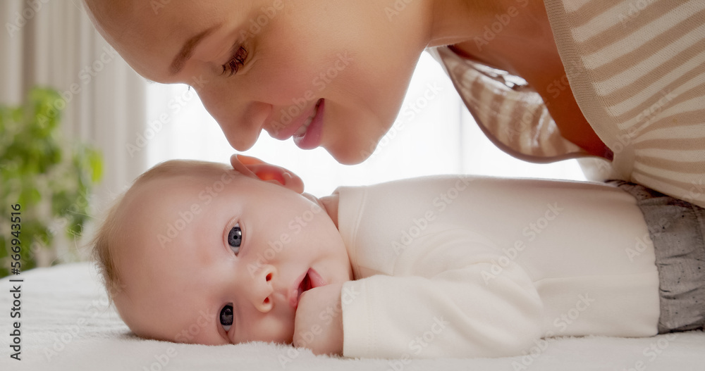 Young happy mother looks in her newborn baby, one-month old. Happy mom looking on a beautiful infant son. Mum loves of her infant child. Parenthood concept. Happy mom, happy kid. Young happy mother looks in her newborn baby, one-month old. Happy mom looking on a beautiful infant son. Mum loves of her infant child. Parenthood concept. Happy mom, happy kid.