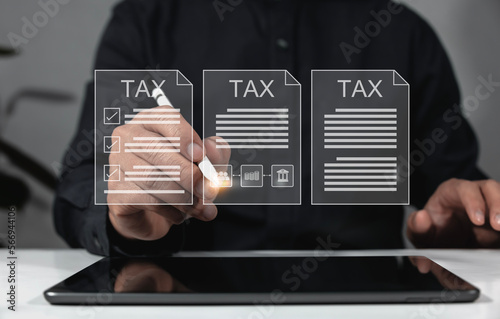 concept of the concept of the tax payer Examination of documents related to tax payment Businessman filling out and calculating tax payment online documents for annual tax payment.